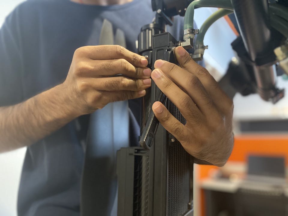 Alphaswift Industries's employee was fixing the liquid cooling module of the C-24 Falco Hybrid Drone.